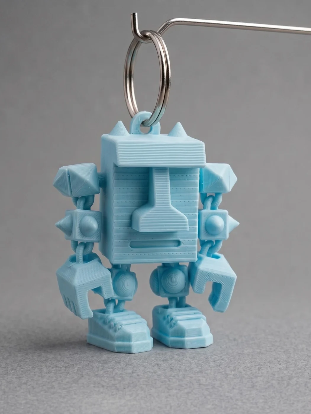 A printed Cubie on a key ring, with chain arms and claws