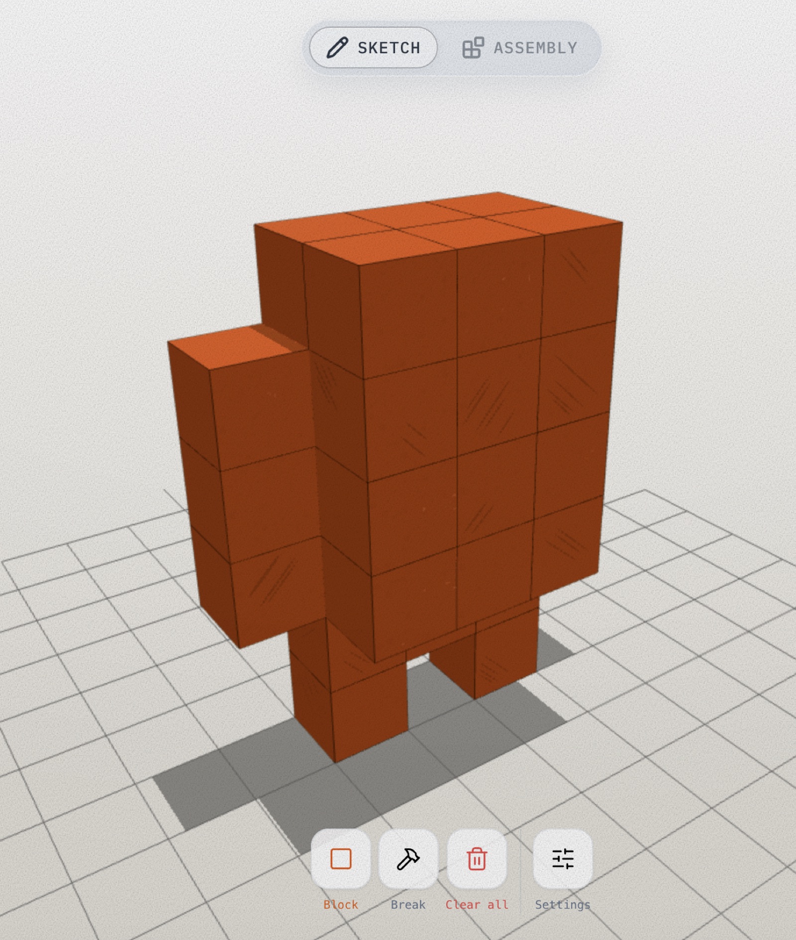 Cubie desktop — a half-built red character in Sketch mode, diagonal texture already stamped onto the finished cubes