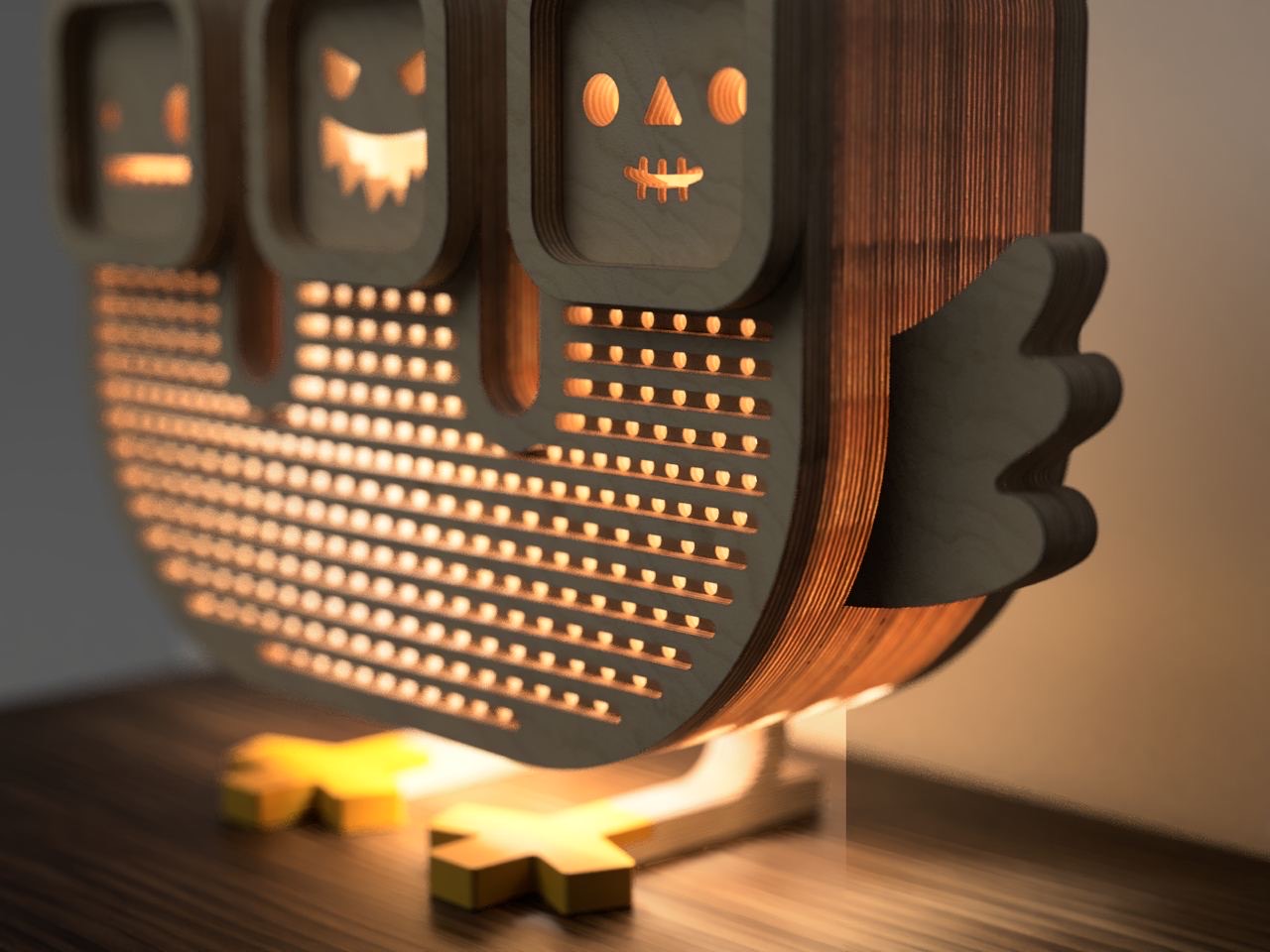 Three Lampuny lined up, each with a different laser-cut face — blank, jack-o'-lantern grin, and a small monster